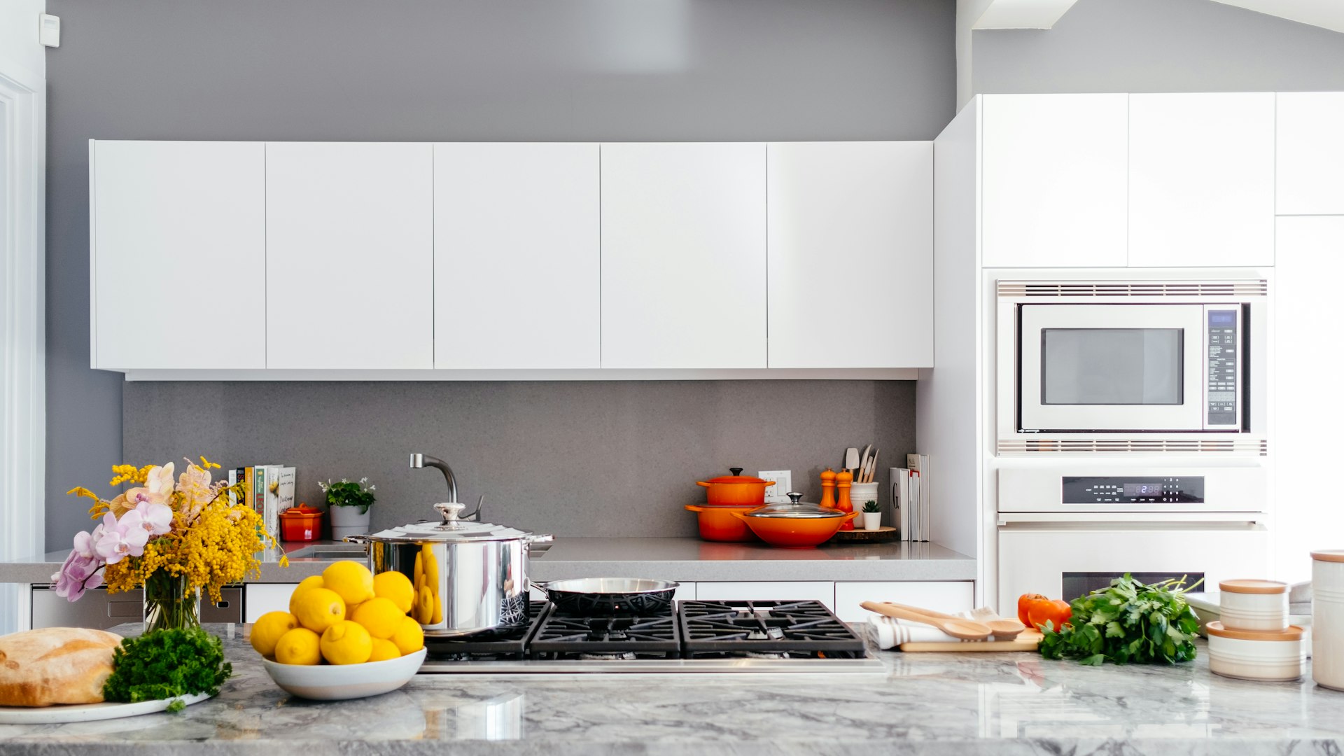 Newly remodeled open-concept kitchen in a Walnut Creek CA home by a local kitchen remodeling contractor β white shaker cabinets and quartz island